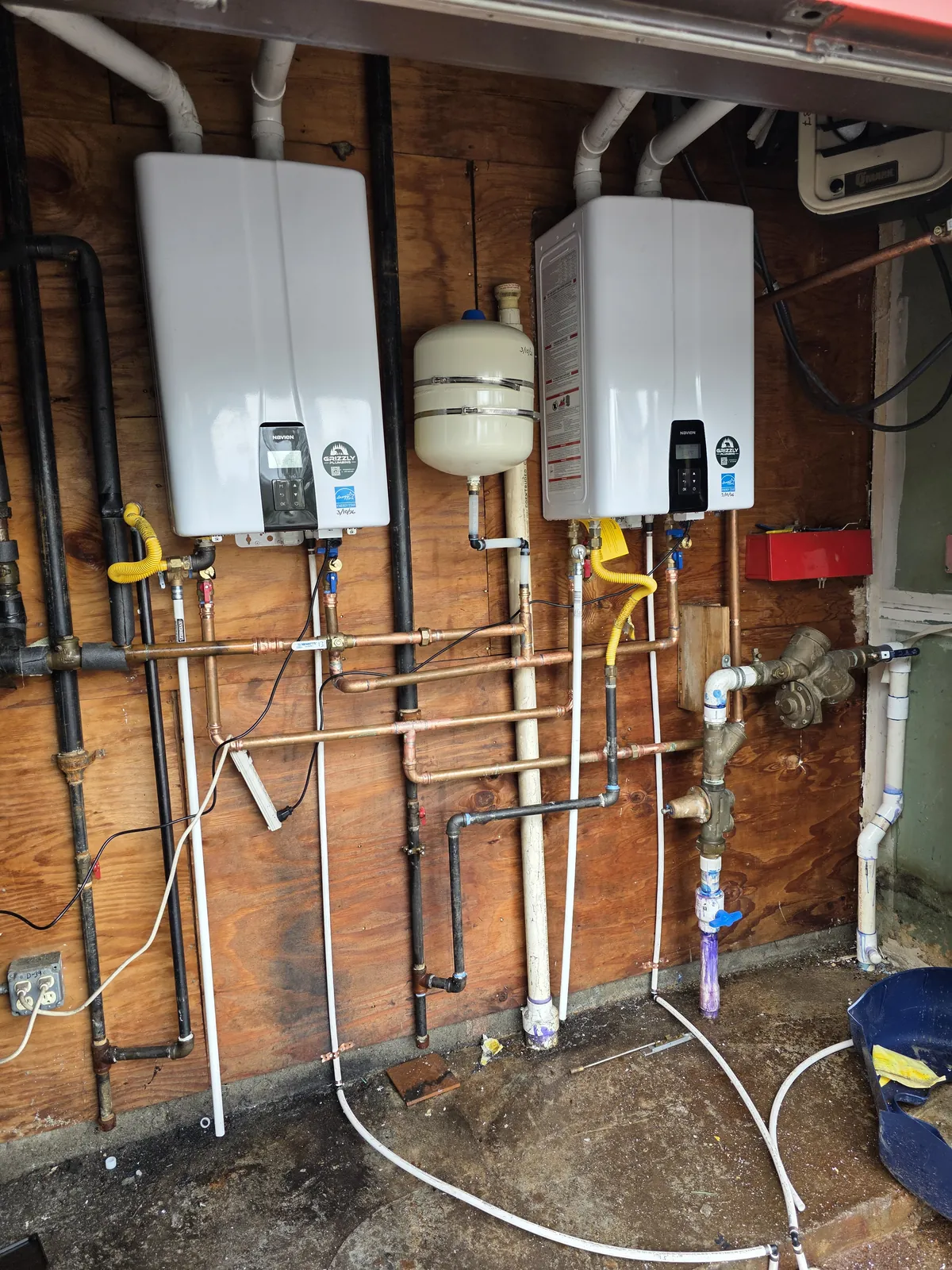 Two Navien tankless water heaters installed side by side by Grizzly Plumbing