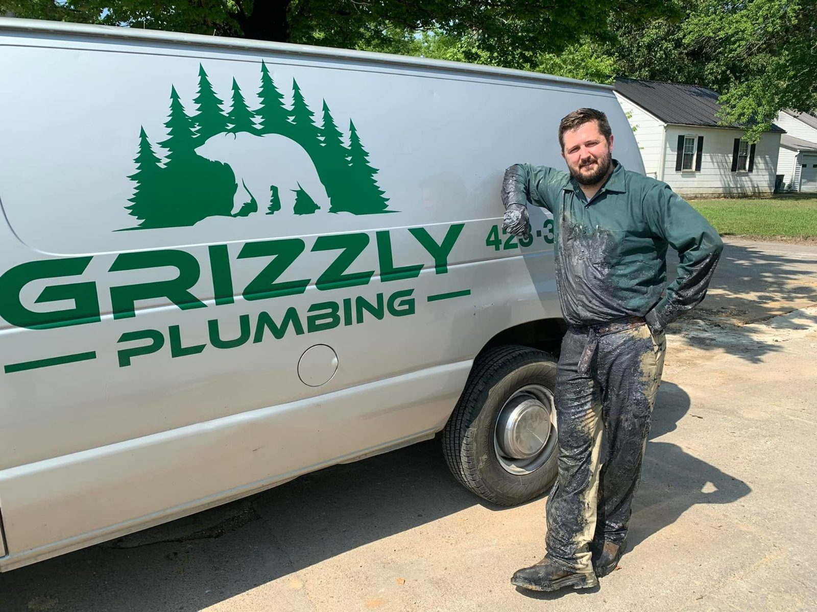 Grizzly Plumbing technician with the service van in Cleveland, TN